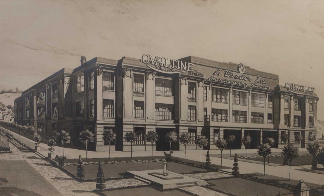 Monochrome architectural rendering of the Ovaltine factory at Kings Langley, with the Ovaltine, A. Wander Ltd and Cristolax signs along the roofline and formal gardens in front.